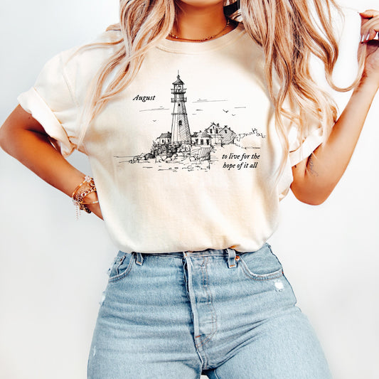 Person wearing a t-shirt with a lighthouse graphic and text.