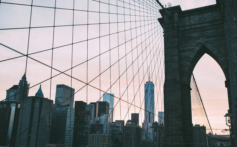 City skyline with skyscrapers and brooklyn bridge at sunset