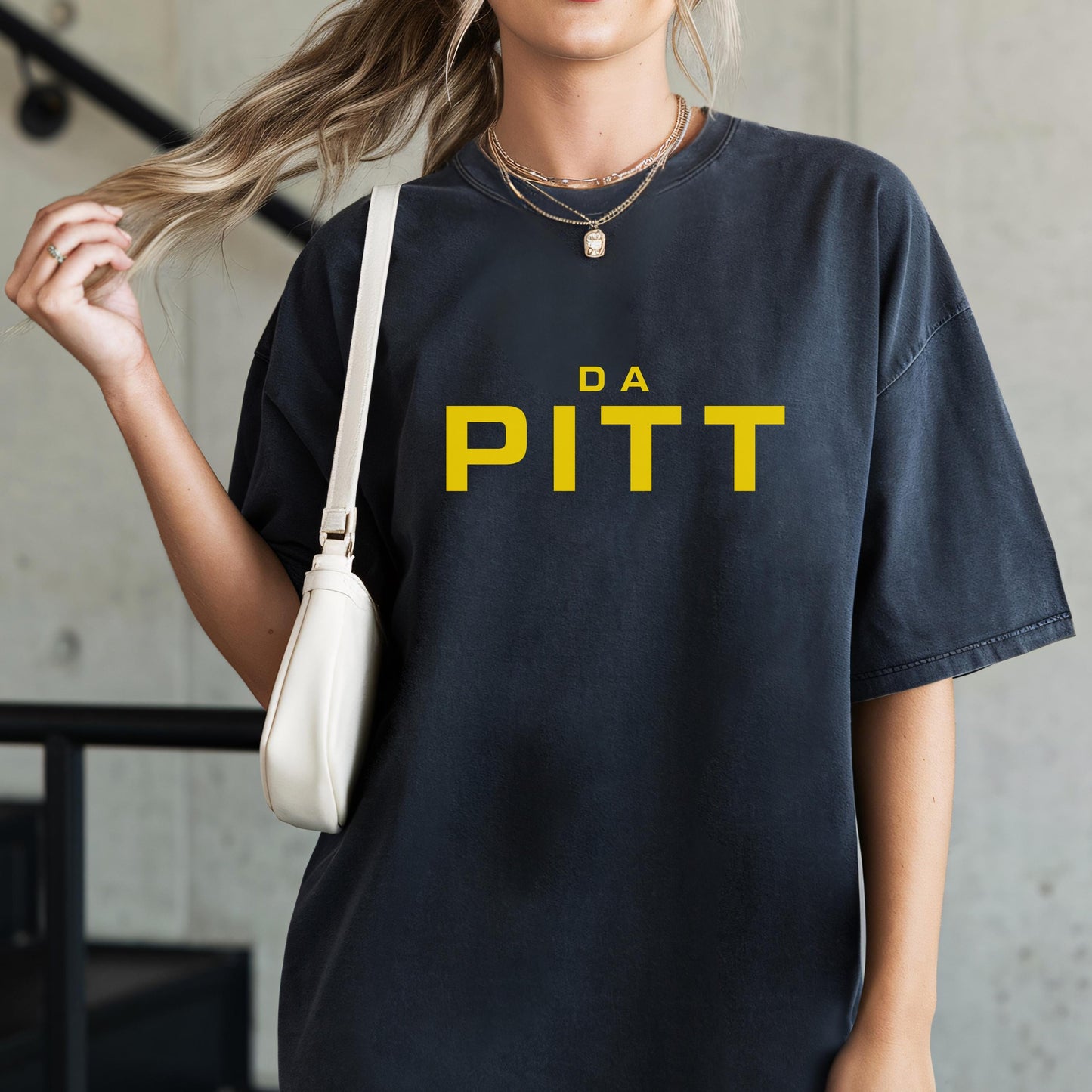 Black unisex t-shirt with yellow “DA PITT” text, styled casual streetwear.